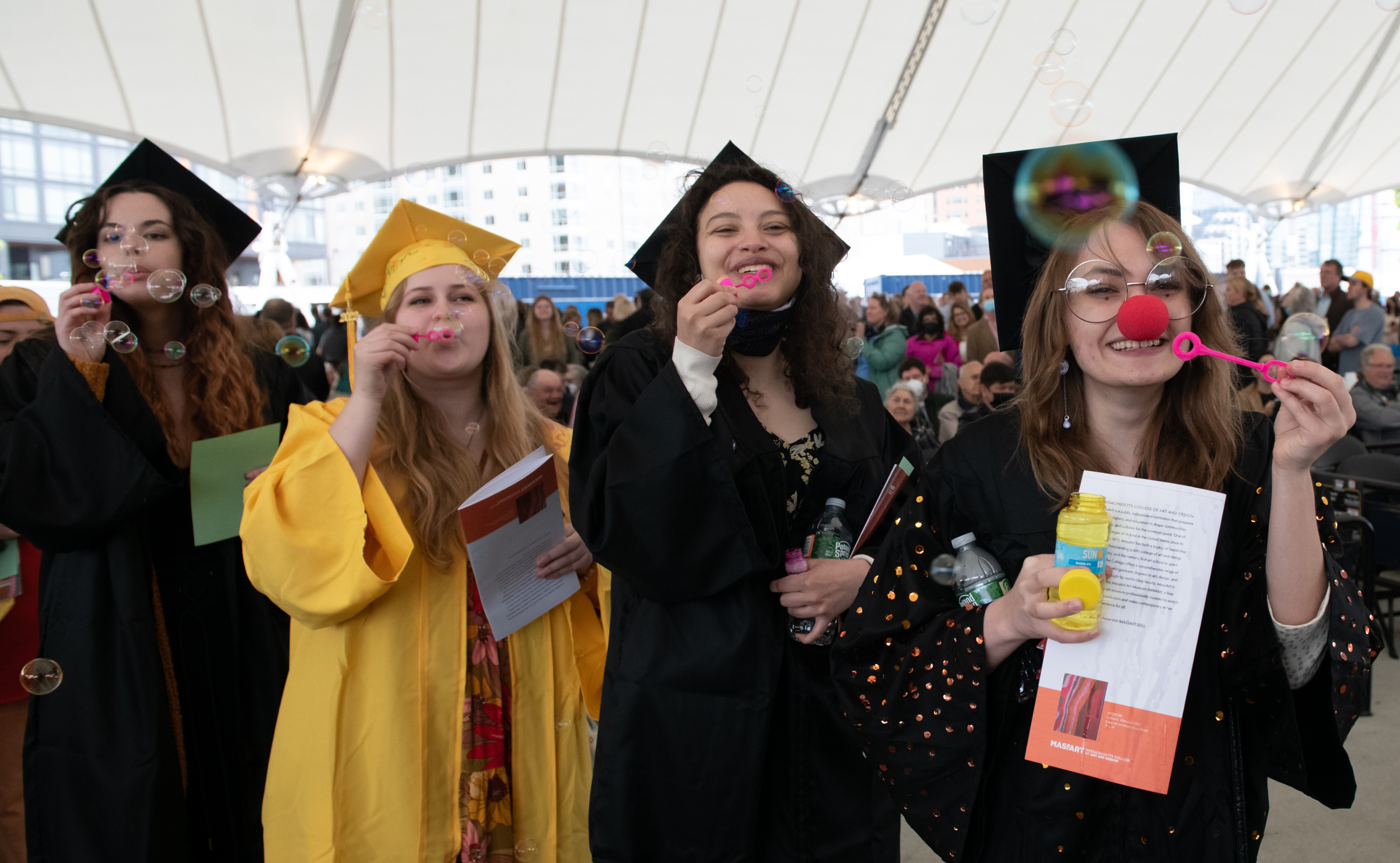 MassArt Students blowing bubbles at MassArt Commencement 2022