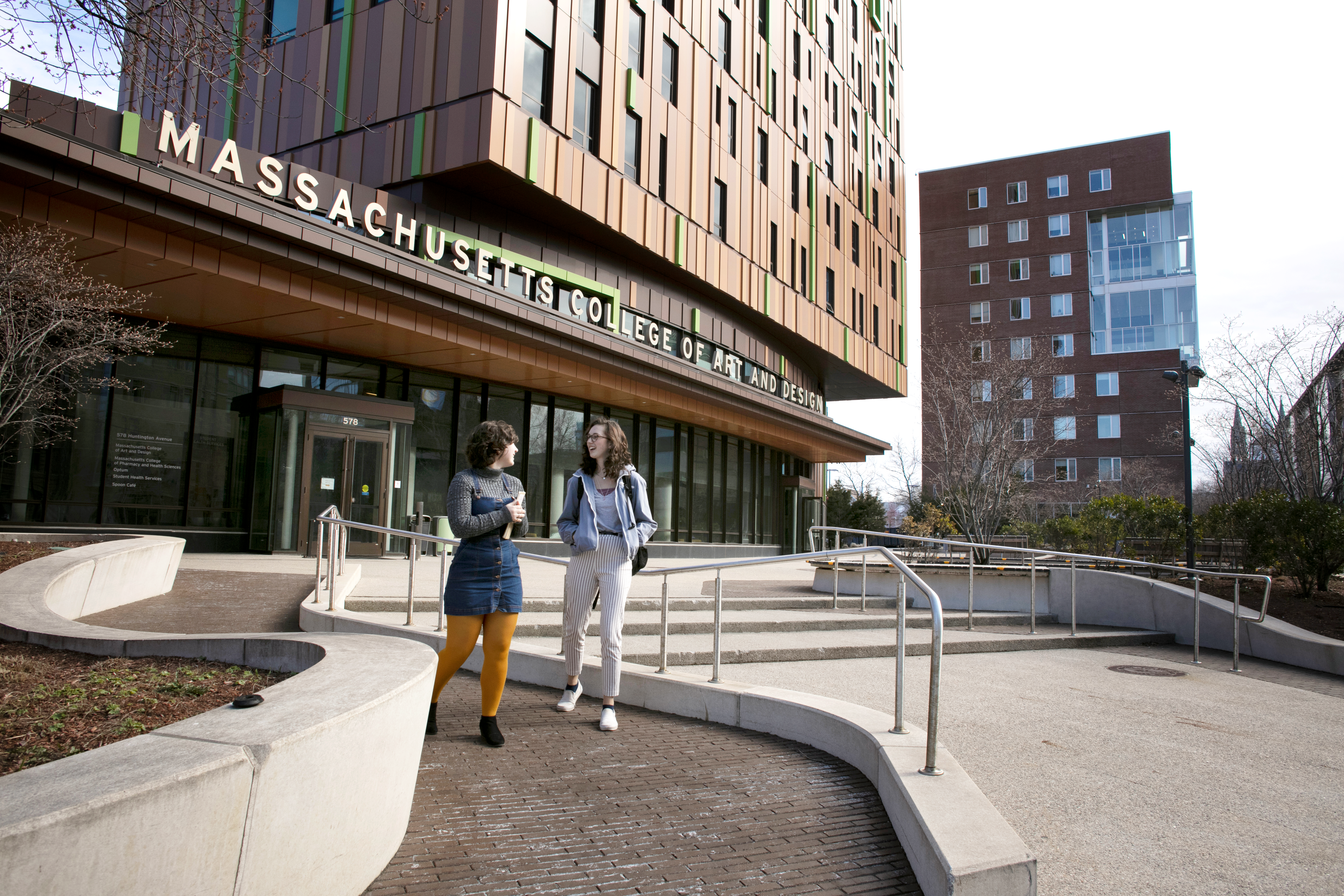Students walking and talking outside of MassArt Treehouse
